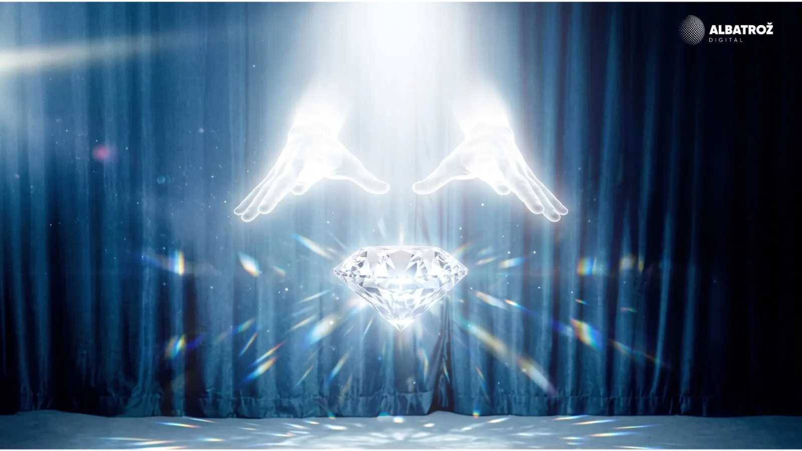 Glowing hands conjuring a cut diamond from a beam of light against a stage curtain